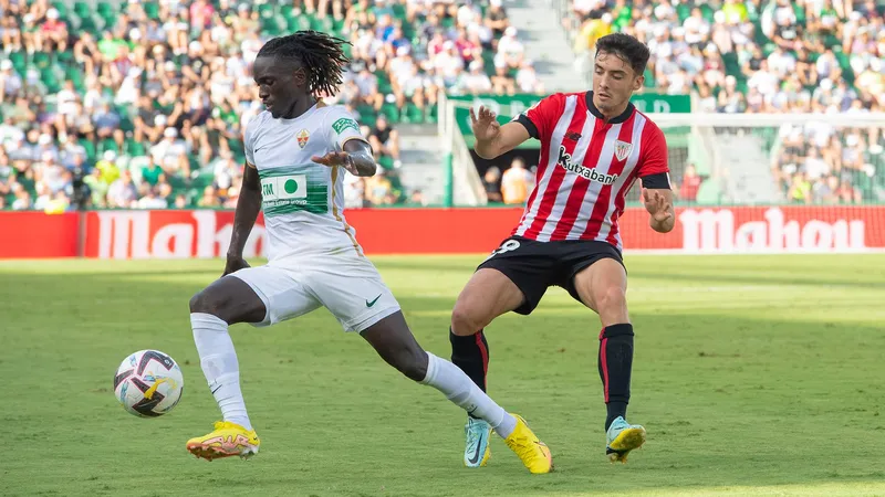 Cầu thủ Athletic Bilbao và Elche đang tranh chấp bóng trên sân Cầu thủ Athletic Bilbao và Elche đang tranh chấp bóng trên sân